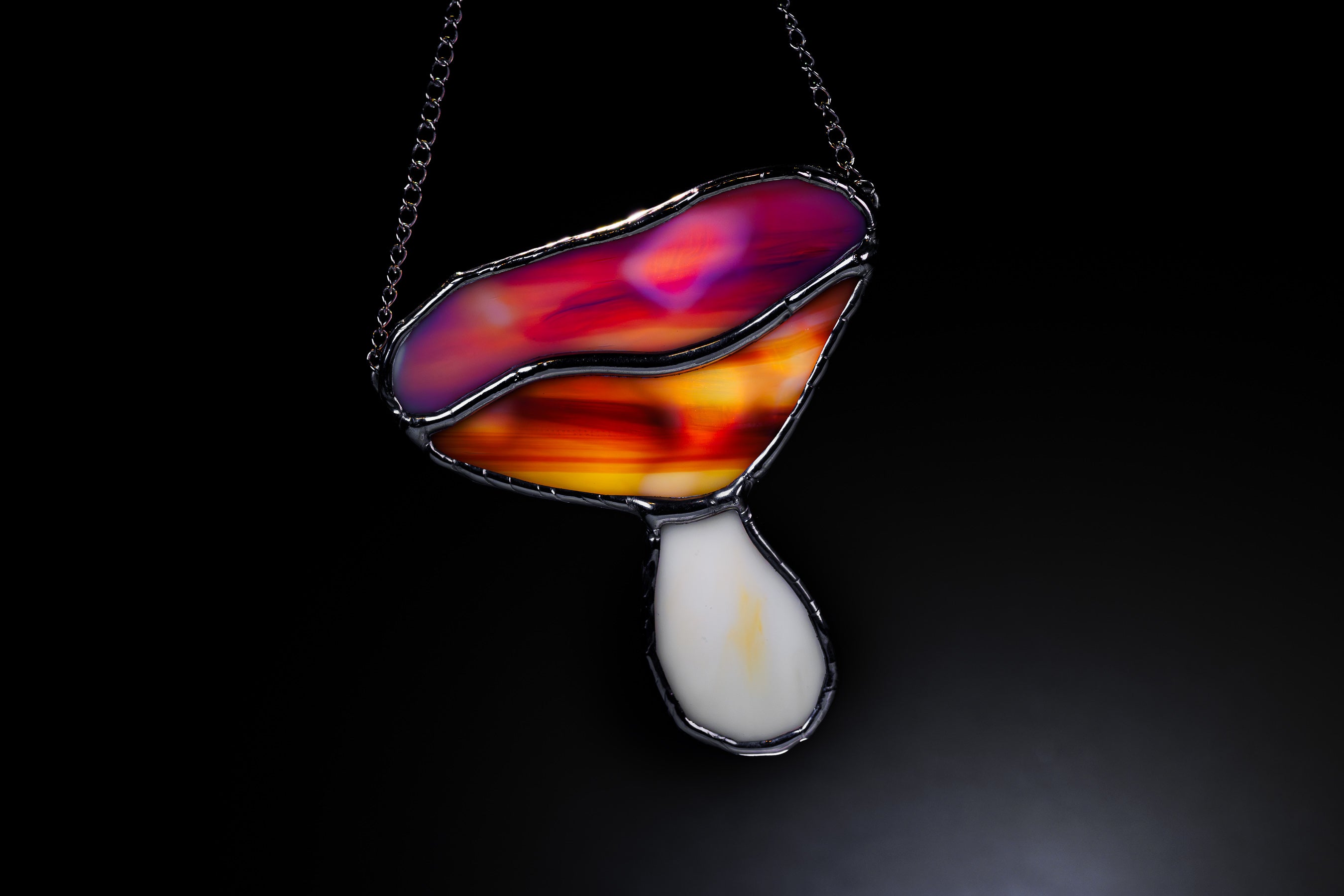 Colorful mushroom suncatcher with a dark background